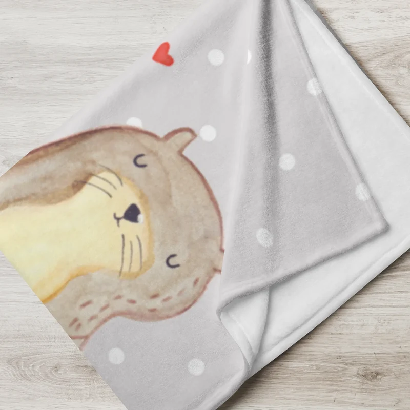 Babydecke Otter Hände halten